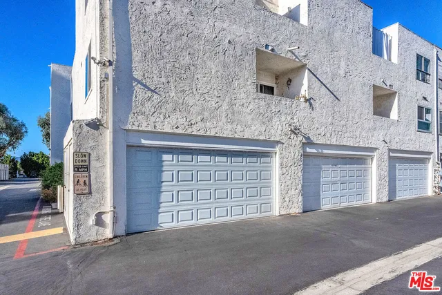 front view of a brick house with large windows