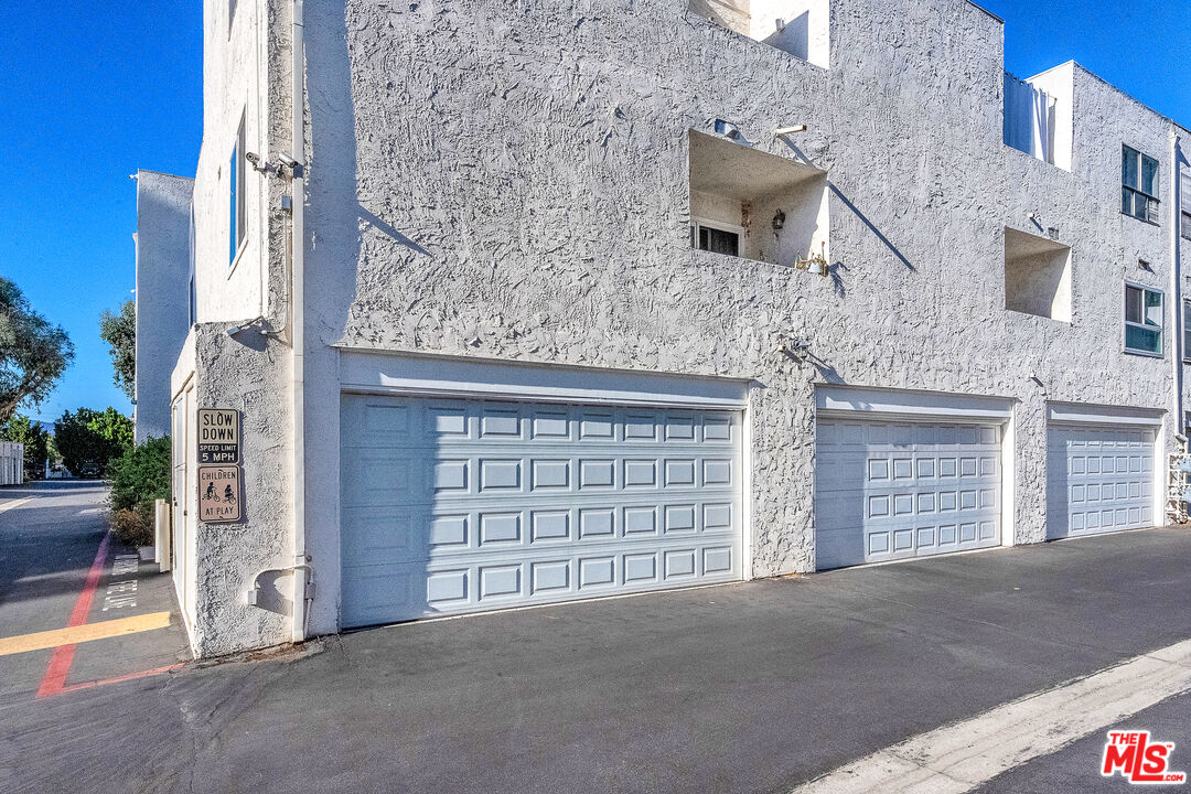 18411 Hatteras Street, Unit 114 Tarzana, CA 91356 - Photo 18 of 19 front view of a brick house with large windows