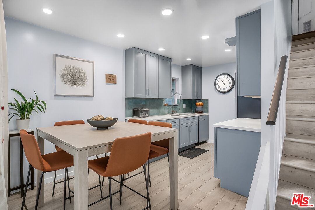 18411 Hatteras Street, Unit 114 Tarzana, CA 91356 - Photo 4 of 19 a kitchen with a table and chairs in it