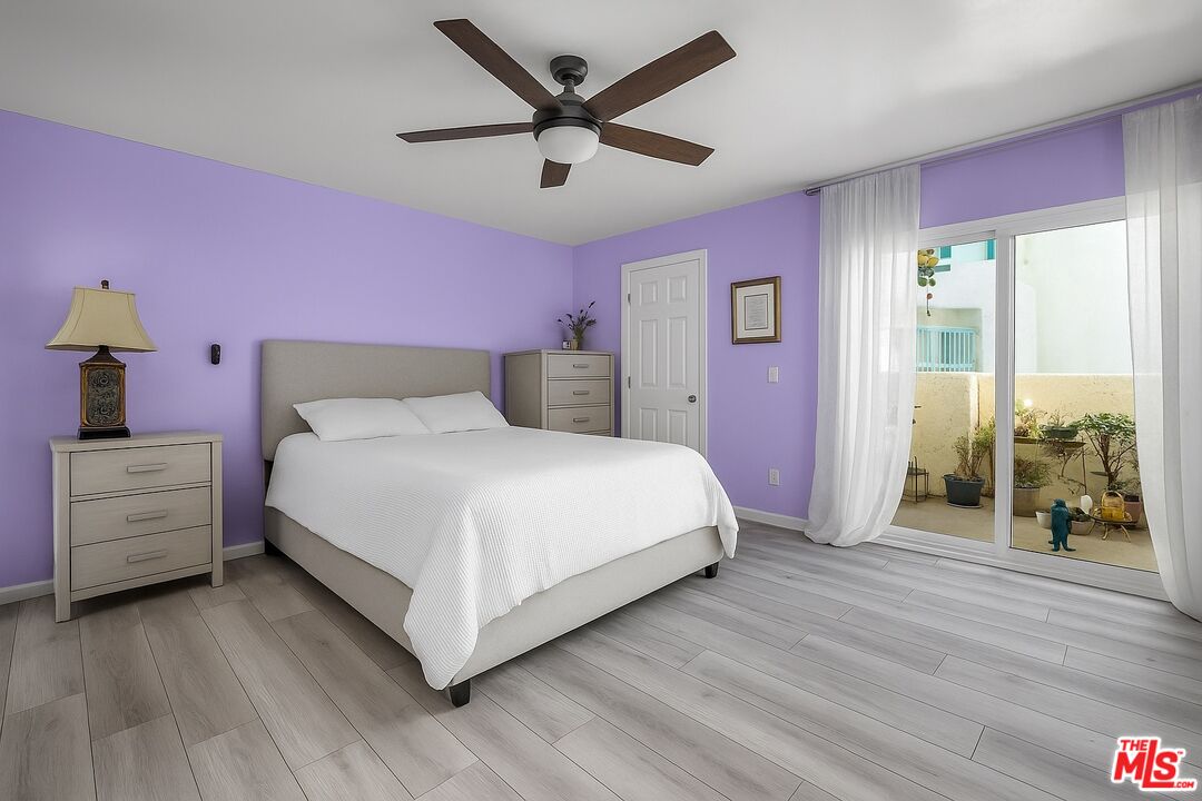 18411 Hatteras Street, Unit 114 Tarzana, CA 91356 - Photo 5 of 19 a bedroom with a bed and a chandelier