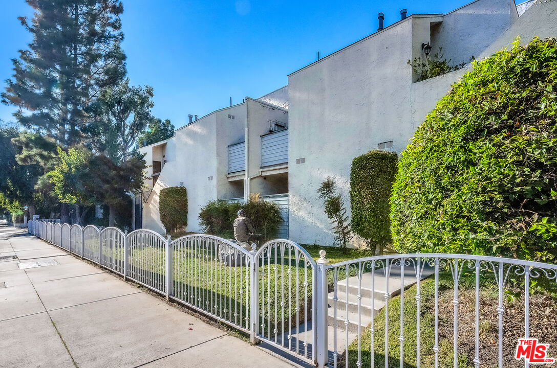18411 Hatteras Street, Unit 114 Tarzana, CA 91356 - Photo 6 of 19 a view of a house with iron fence