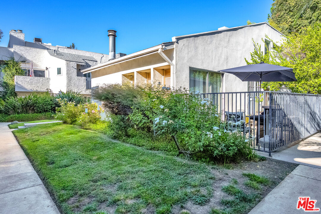 18411 Hatteras Street, Unit 114 Tarzana, CA 91356 - Photo 9 of 19 a front view of a house with garden