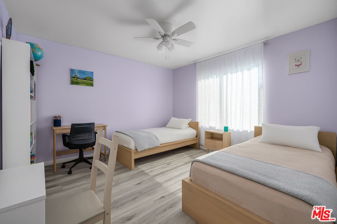 18411 Hatteras Street, Unit 114 Tarzana, CA 91356 - Photo 10 of 19 a bedroom with a bed and a couch