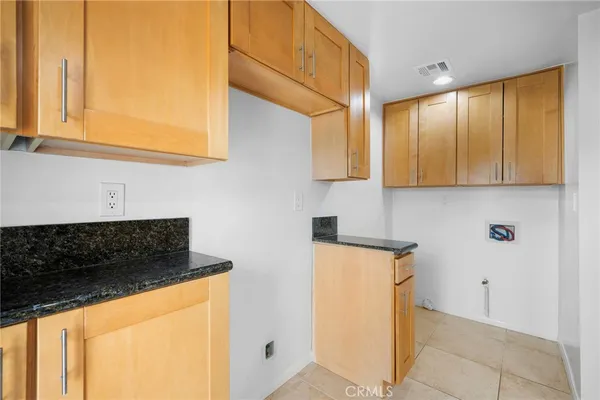 a kitchen with stainless steel appliances a stove a microwave and cabinets