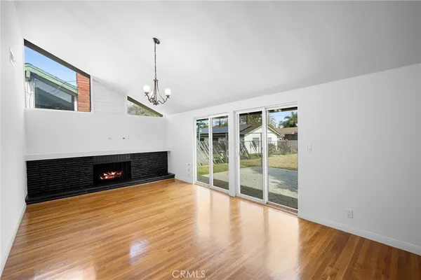 a view of a livingroom with wooden floor and a ceiling fan