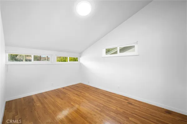 a view of a room with wooden floor