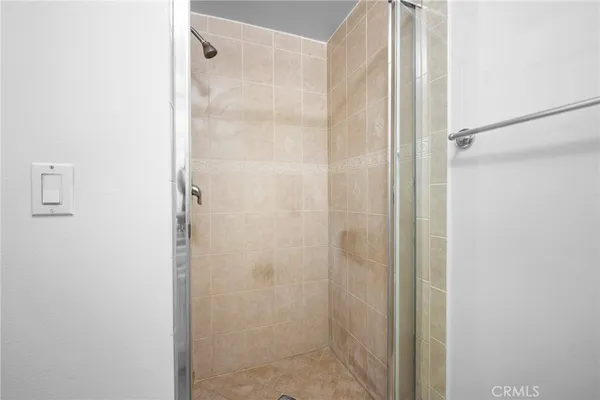 a bathroom with a glass shower door