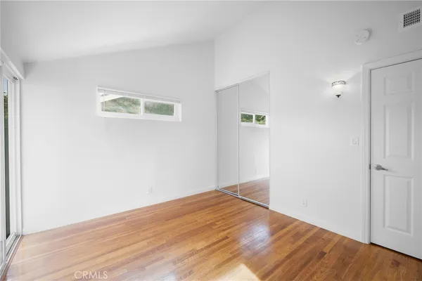 an empty room with wooden floor