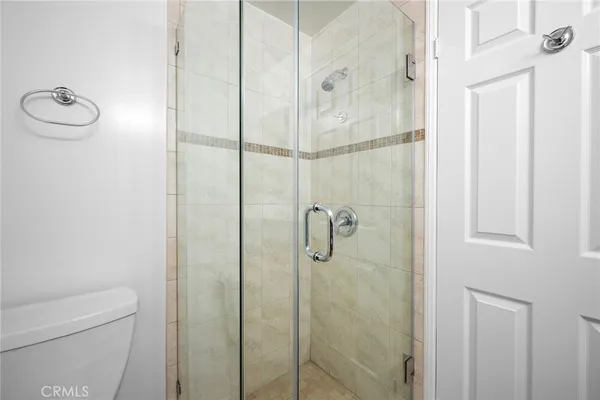 a bathroom with a shower and toilet