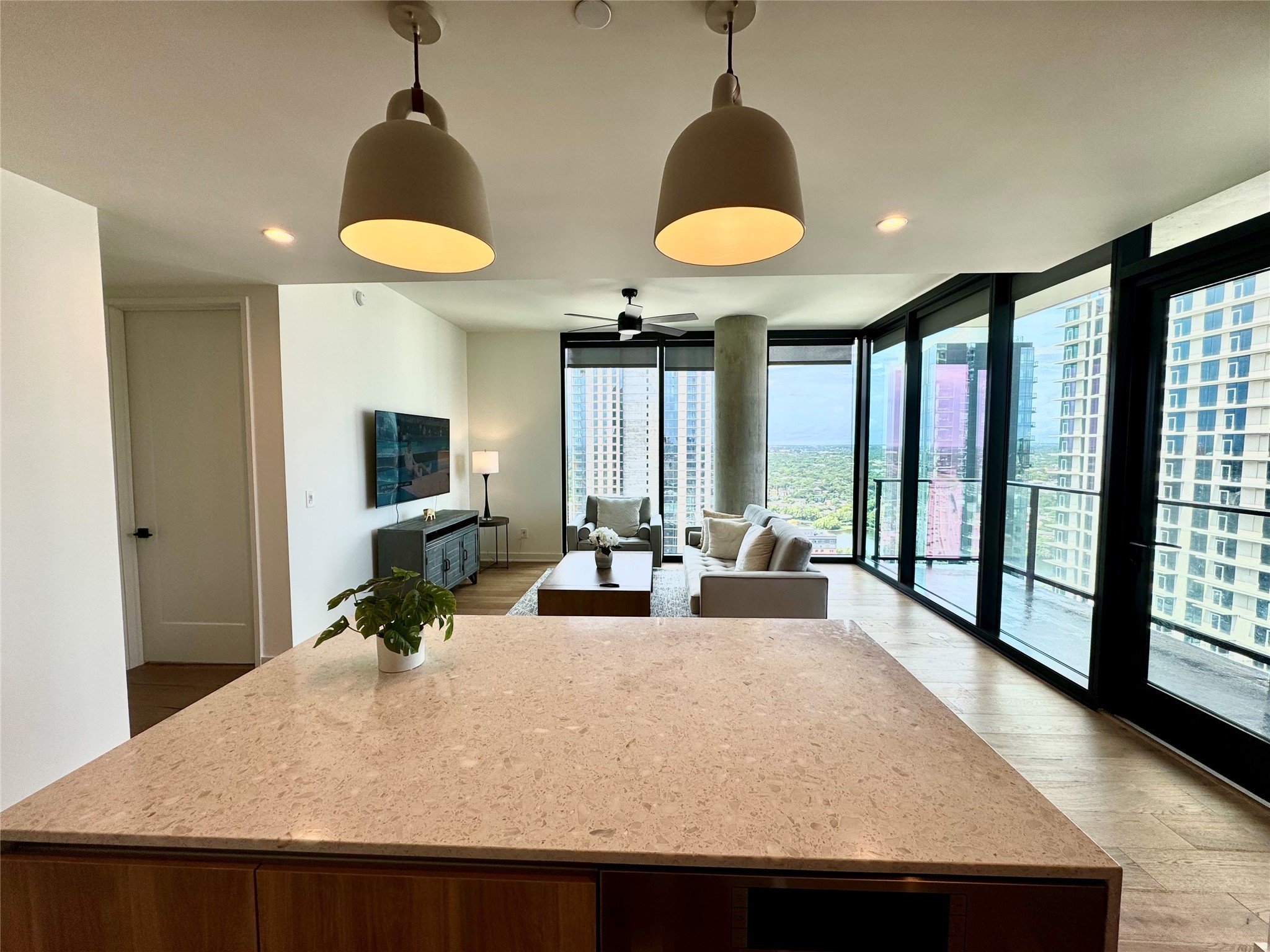 84 East Avenue, Unit 3009 Austin, TX 78701 - Photo 12 of 39 a living room with furniture a window and a chandelier