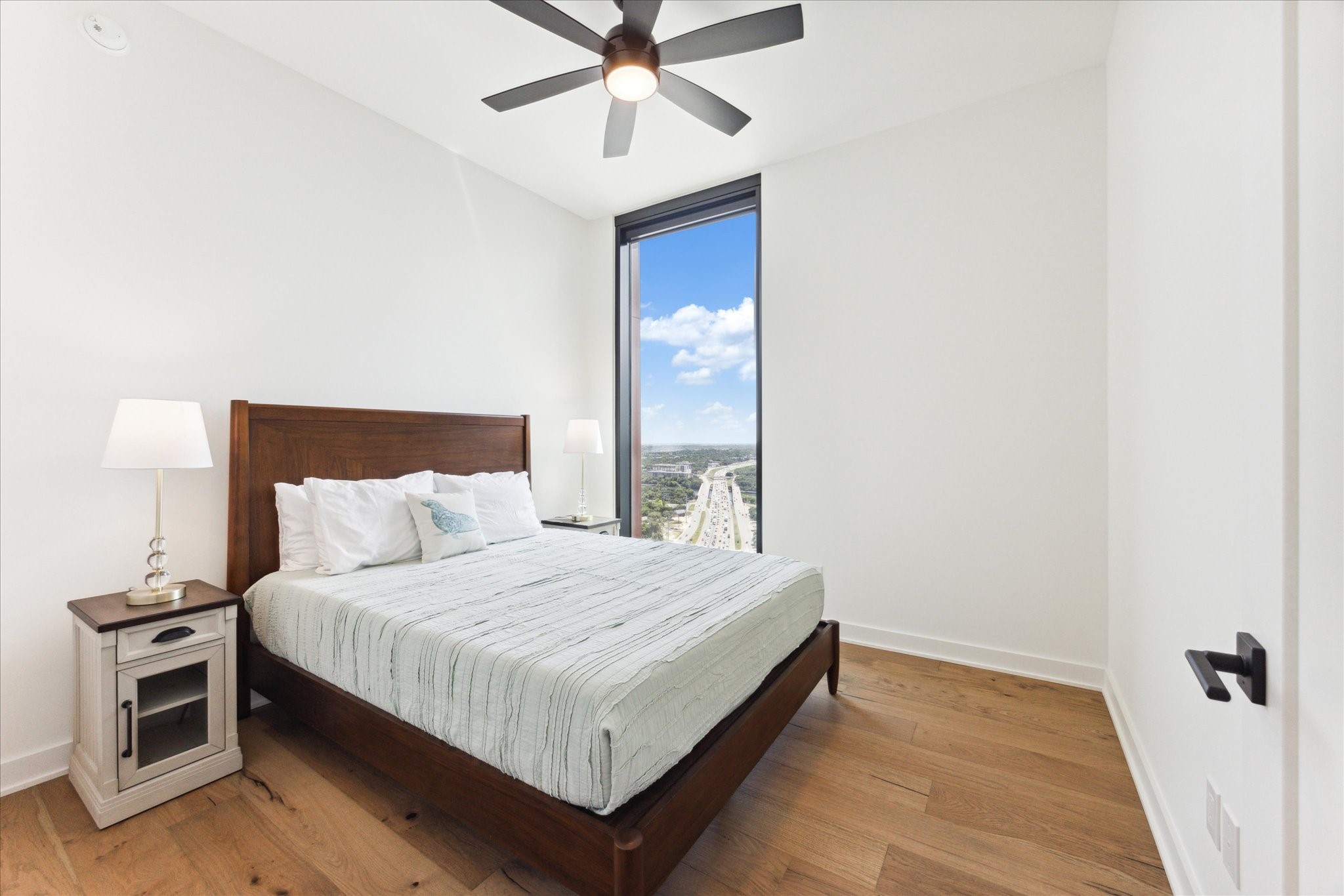 84 East Avenue, Unit 3009 Austin, TX 78701 - Photo 14 of 39 a bedroom with a bed and a chandelier