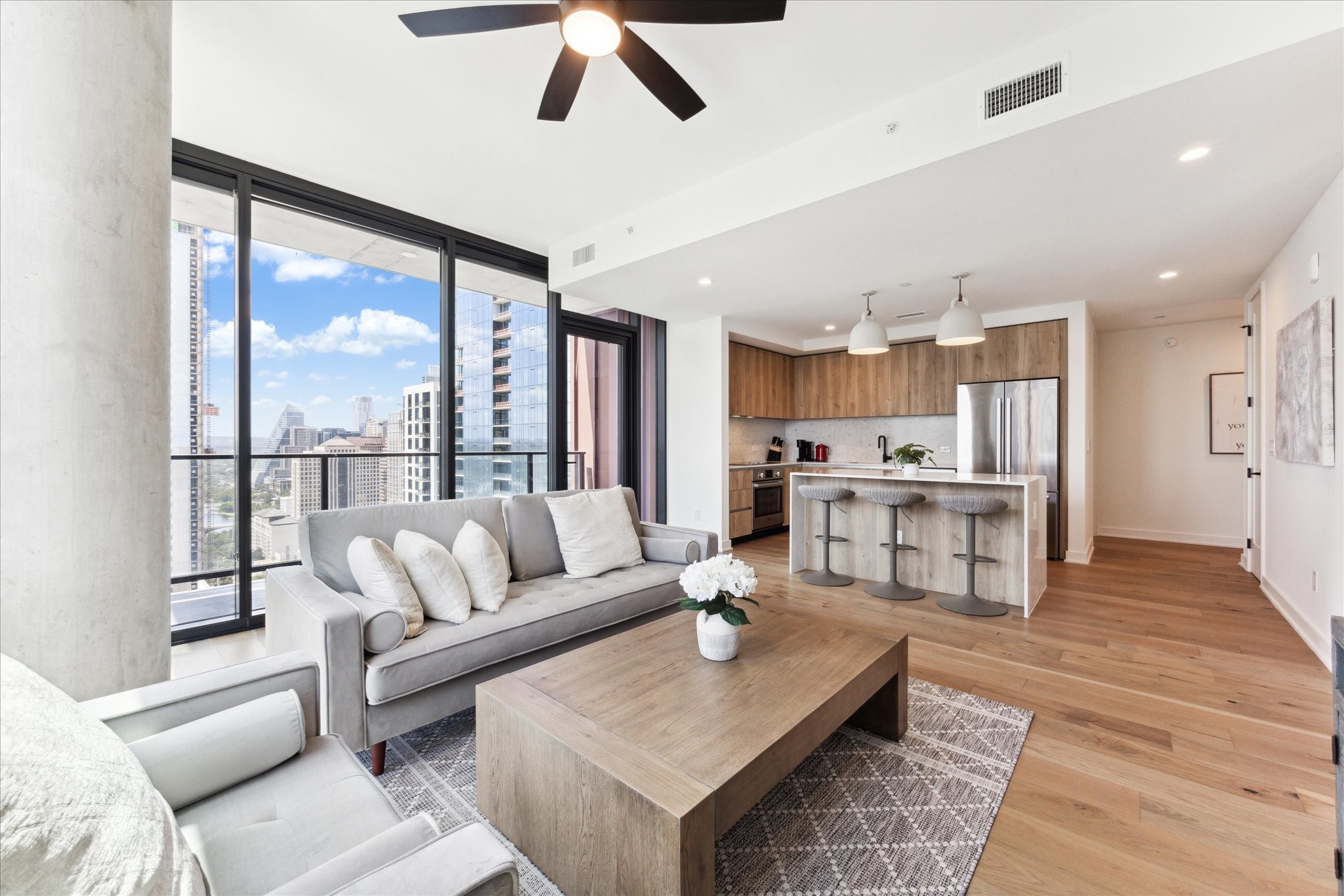 84 East Avenue, Unit 3009 Austin, TX 78701 - Photo 4 of 39 a living room with furniture and a large window