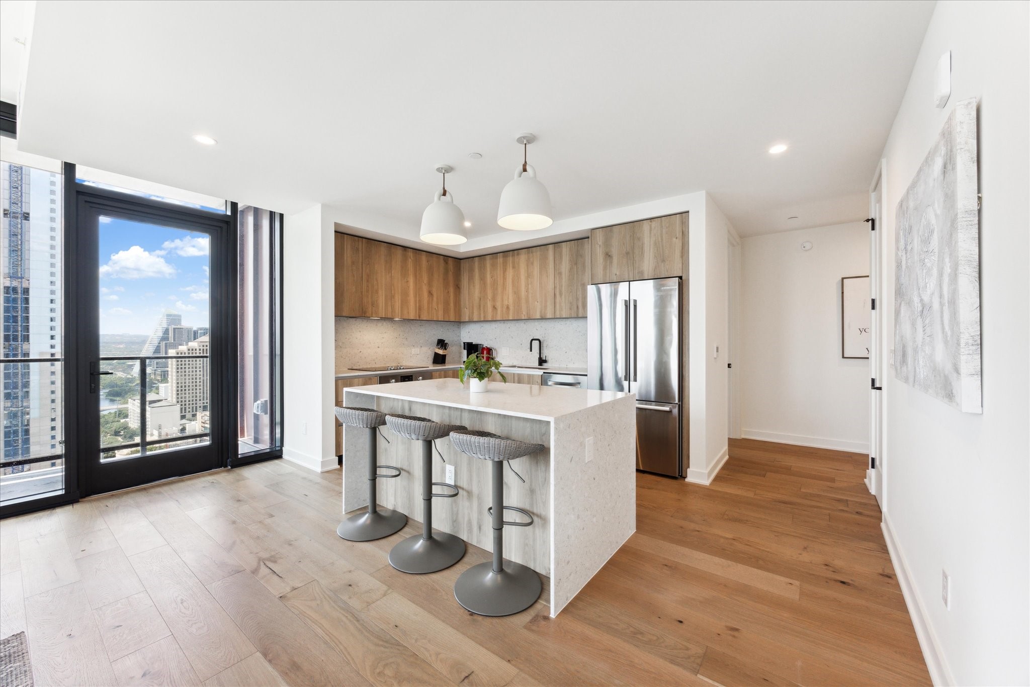 84 East Avenue, Unit 3009 Austin, TX 78701 - Photo 8 of 39 a kitchen with a sink cabinets and wooden floor