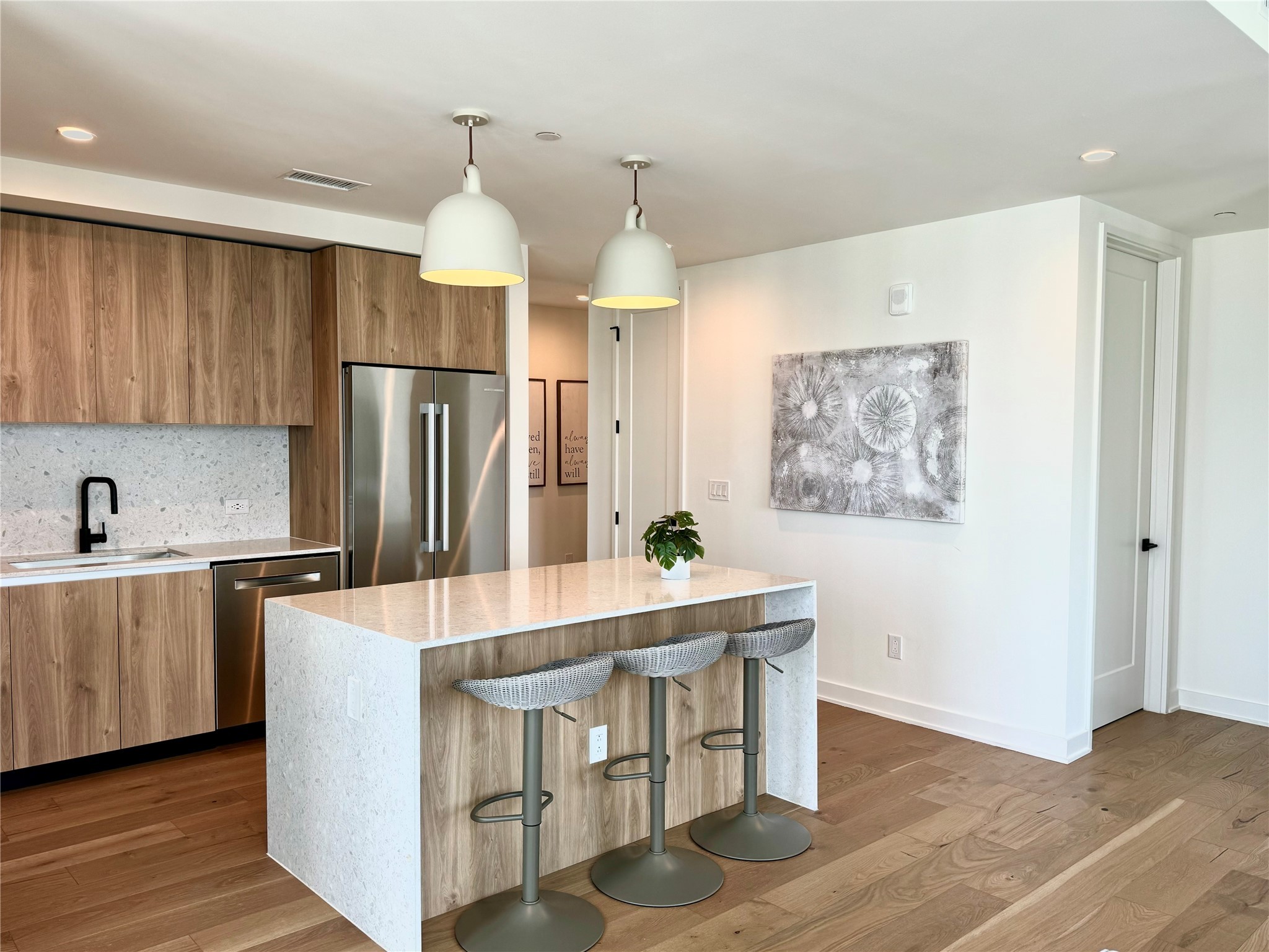 84 East Avenue, Unit 3009 Austin, TX 78701 - Photo 9 of 39 a kitchen with stainless steel appliances a dining table chairs and refrigerator