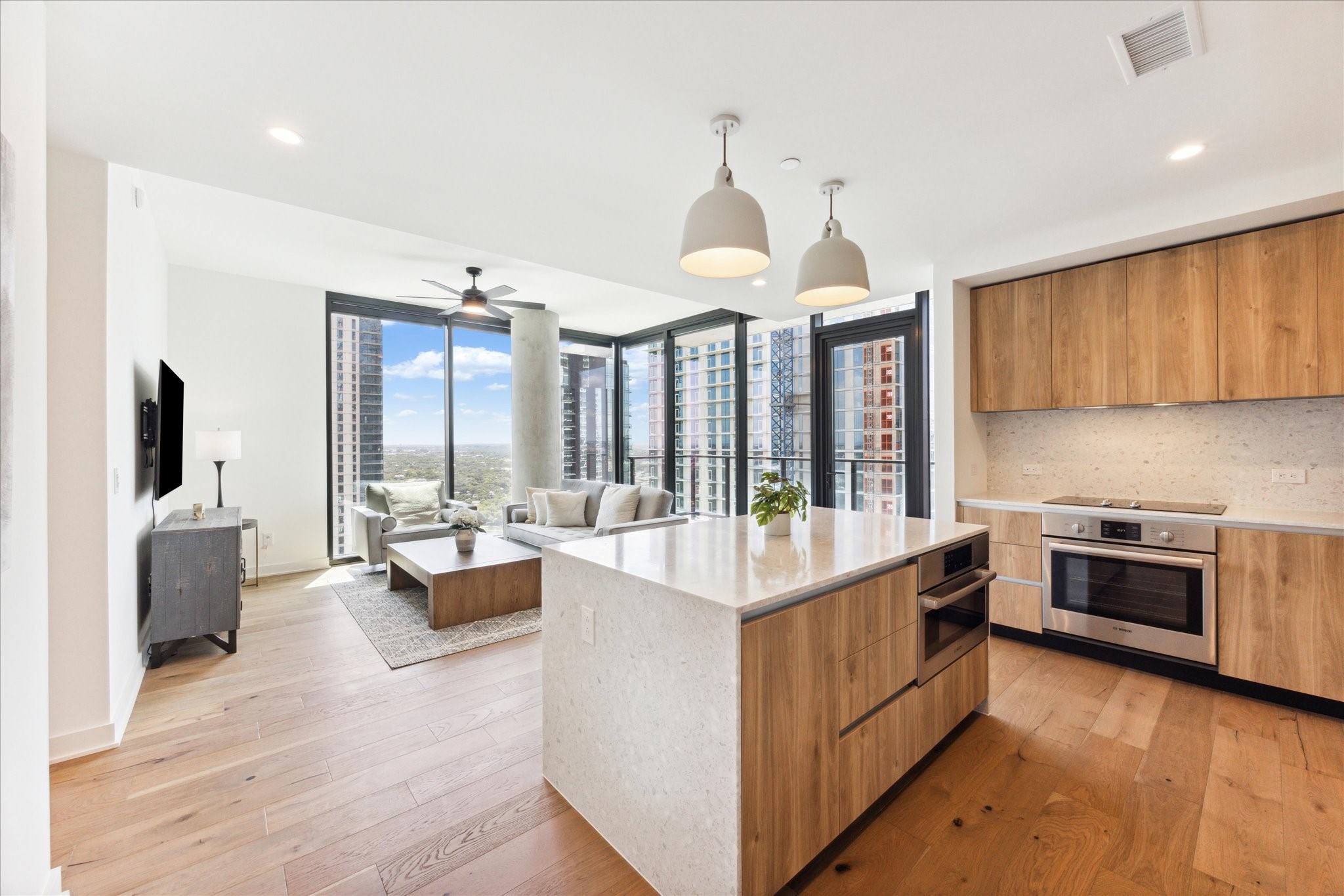 84 East Avenue, Unit 3009 Austin, TX 78701 - Photo 10 of 39 a large white kitchen with a large window and stainless steel appliances