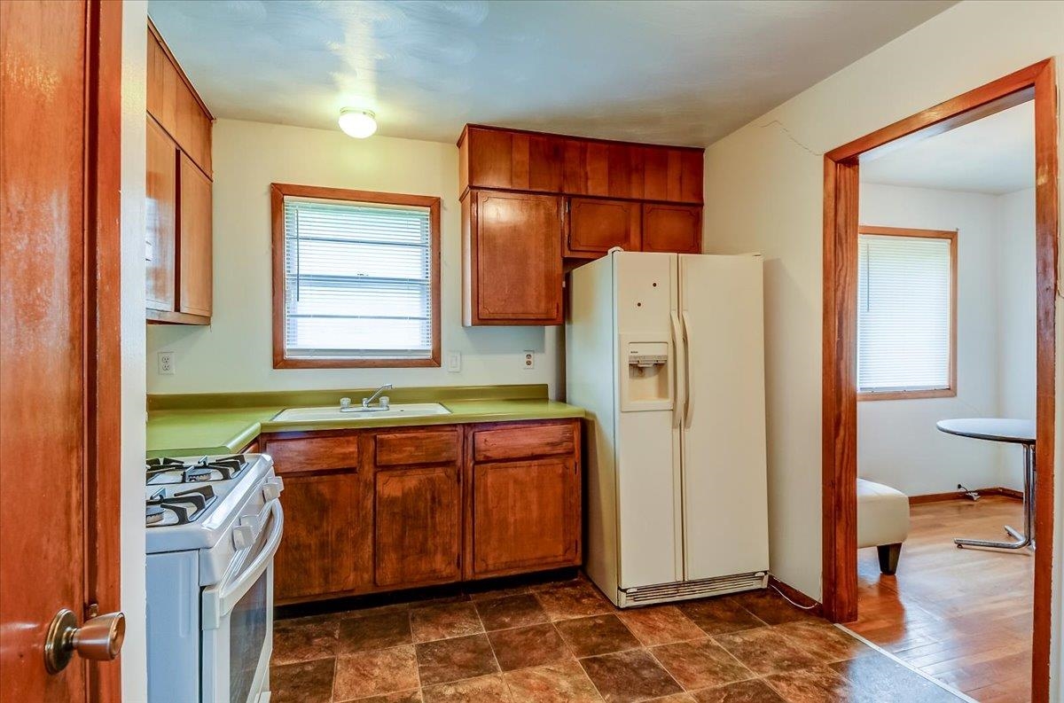 2569 Rozelle Street Memphis, TN 38114 - Photo 14 of 30 Kitchen featuring wood cabinetry, a gas range, and a side-by-side refrigerator