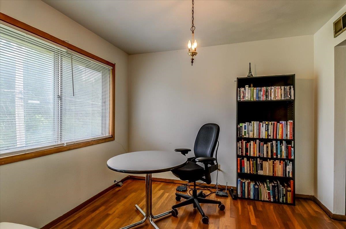 2569 Rozelle Street Memphis, TN 38114 - Photo 16 of 30 Room featuring wood-finish flooring, a large window with blinds, and a built-in overhead light fixture