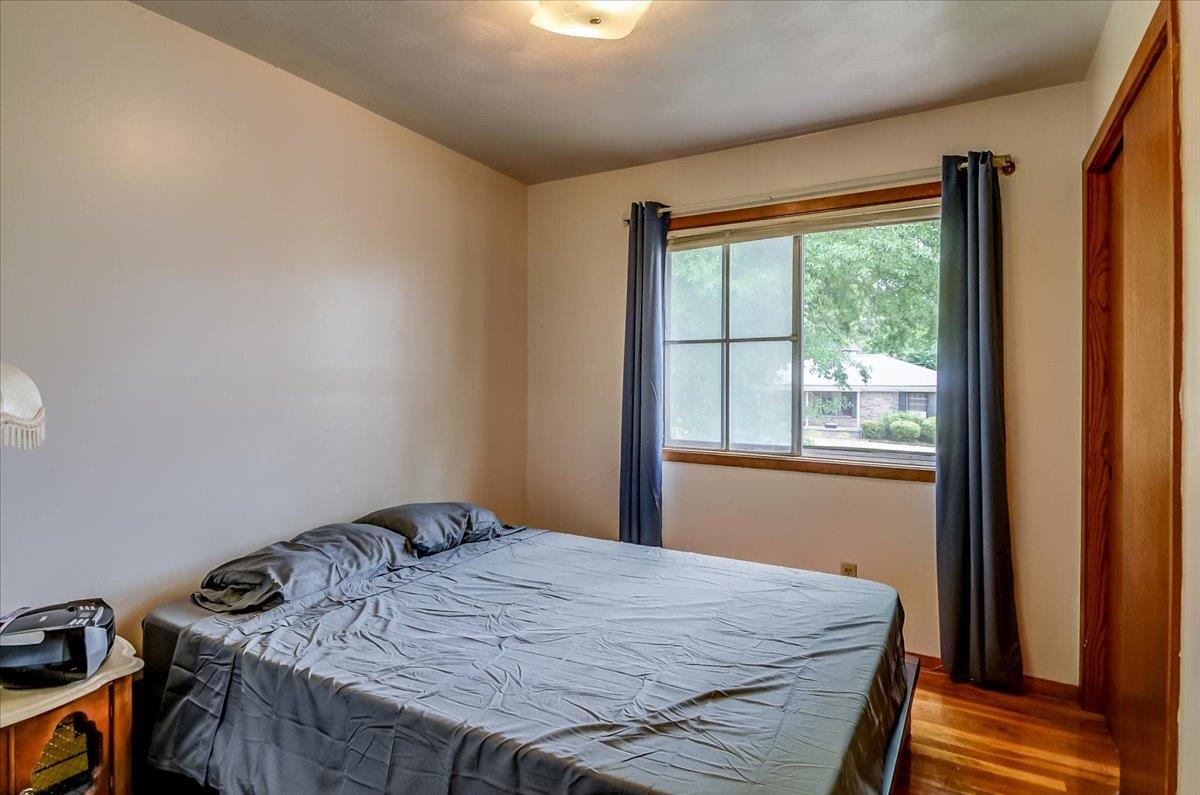 2569 Rozelle Street Memphis, TN 38114 - Photo 18 of 30 Hardwood flooring, window with wooden trim, and a flush mount ceiling light fixture