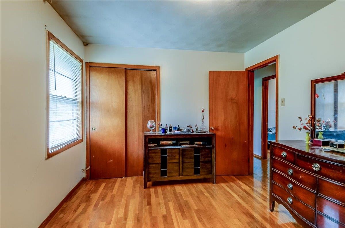 2569 Rozelle Street Memphis, TN 38114 - Photo 23 of 30 Bright room featuring wood-finish flooring, a double-panel sliding closet, and a light-filled window
