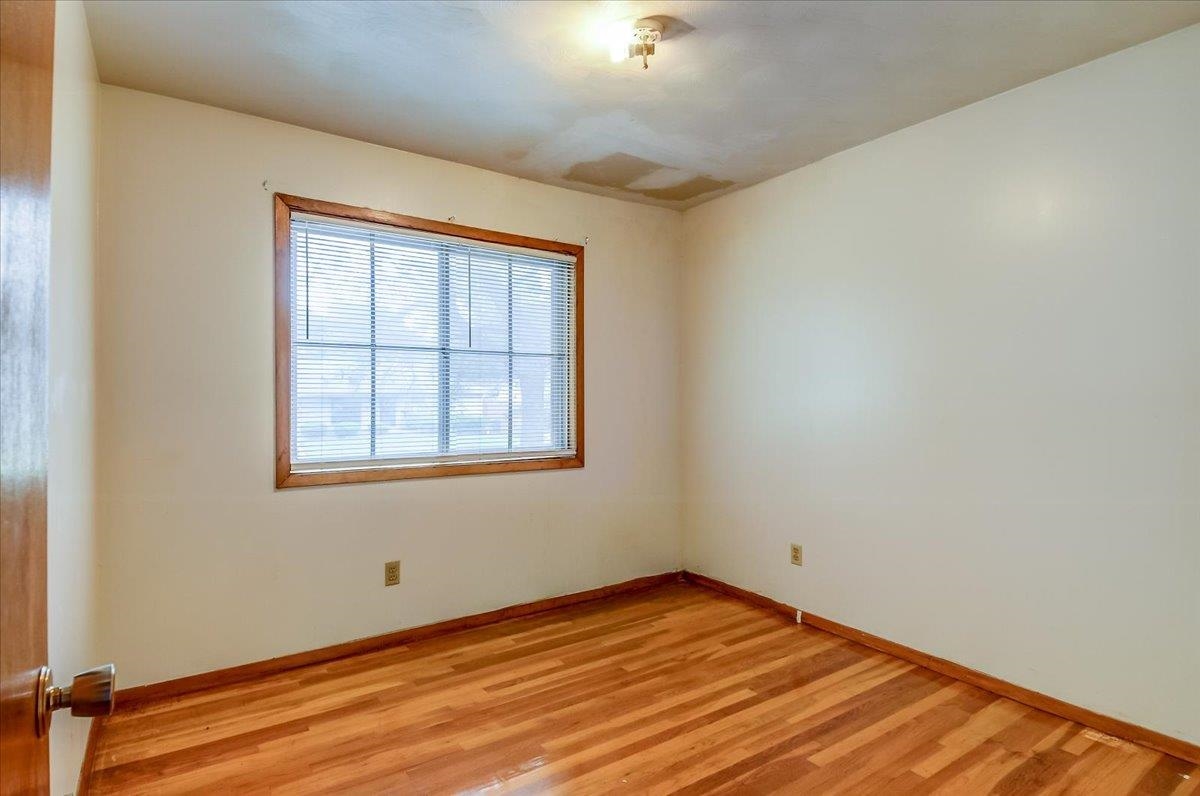2569 Rozelle Street Memphis, TN 38114 - Photo 25 of 30 Bright room featuring wood-finish flooring and a wood-trimmed window