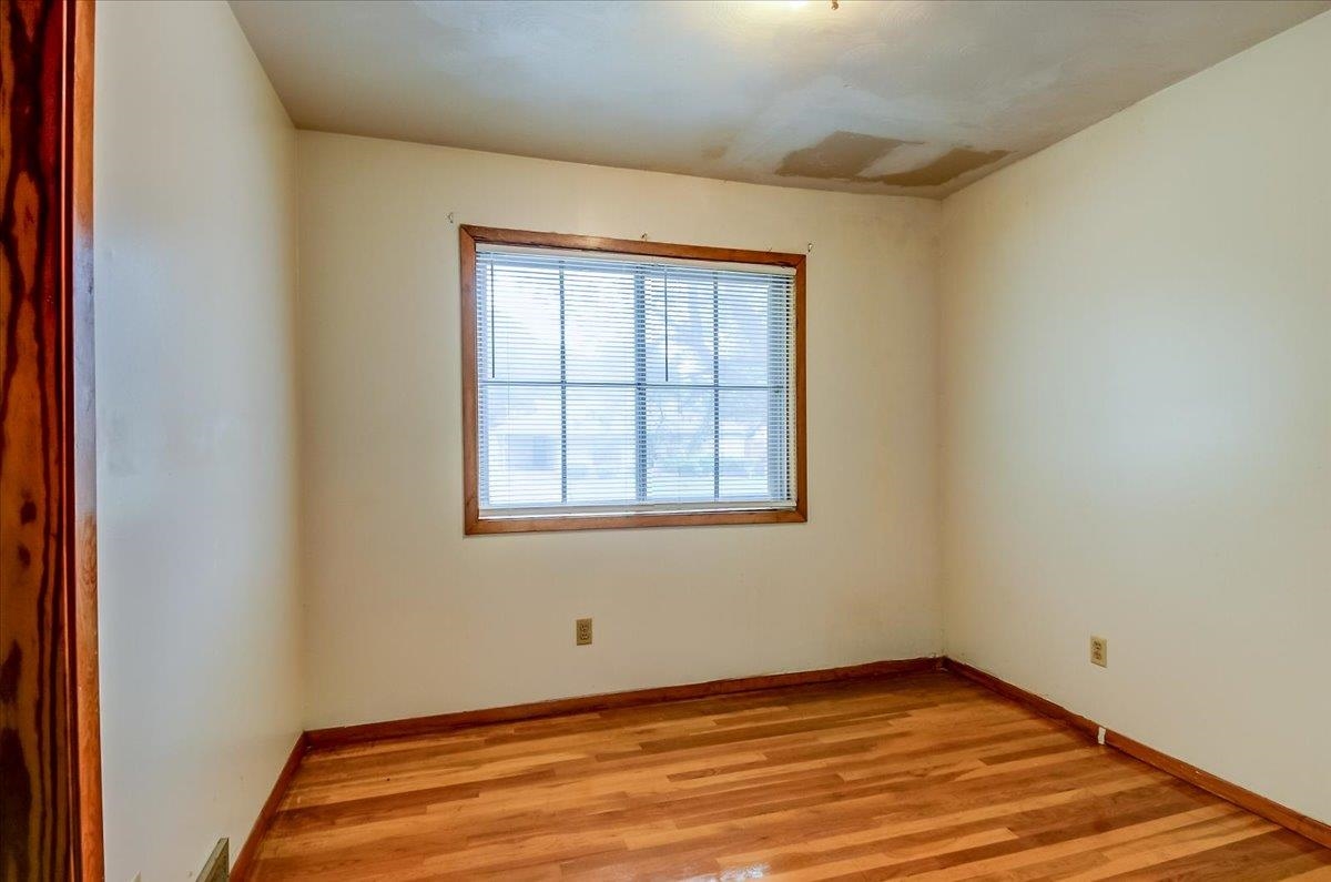 2569 Rozelle Street Memphis, TN 38114 - Photo 26 of 30 Room featuring a single window with blinds, wood-finish flooring, and light-toned walls