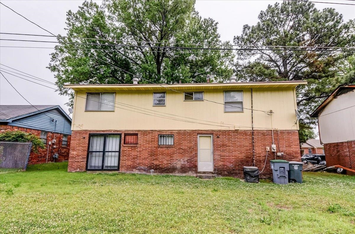 2569 Rozelle Street Memphis, TN 38114 - Photo 28 of 30 Rear facade featuring a brick lower level and yellow siding upper level