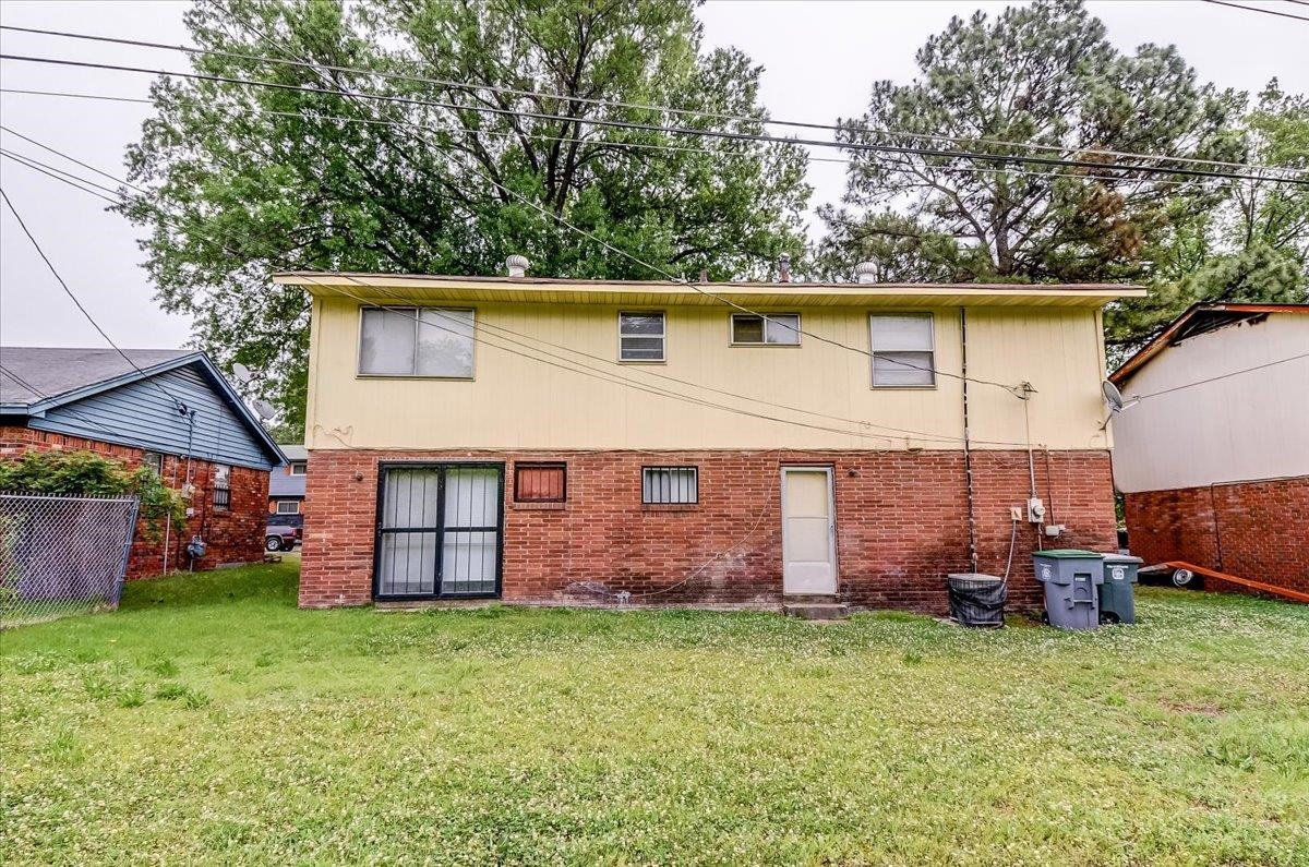 2569 Rozelle Street Memphis, TN 38114 - Photo 30 of 30 Rear exterior featuring yellow siding and brick veneer