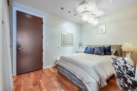 a bedroom with a bed and chandelier