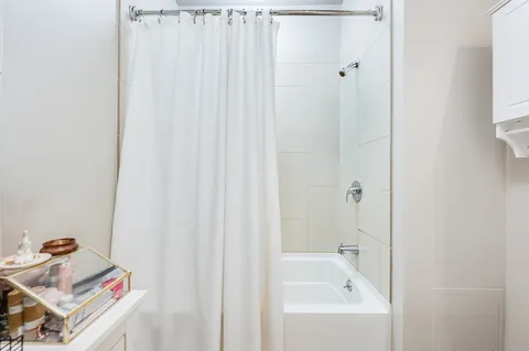 a bathroom with a bathtub and shower