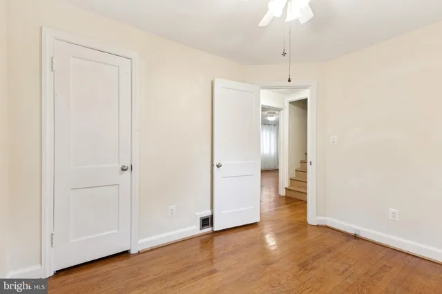 a view of an empty room with wooden floor