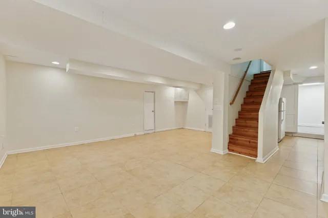 an empty room with a hallway and stairs