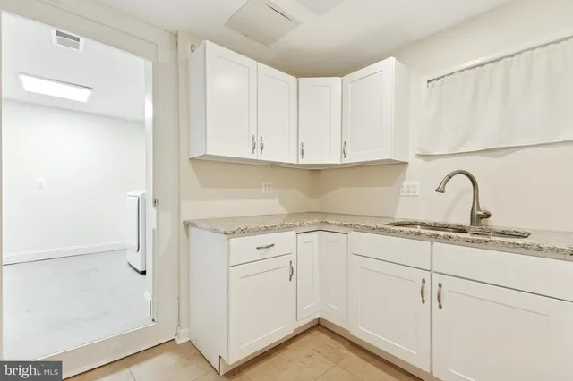 a kitchen with a sink cabinets and appliances
