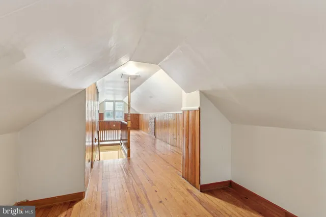 a view of a room with wooden floor table and chairs