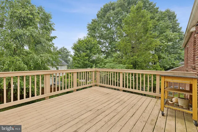 a view of balcony with wooden floor and fence