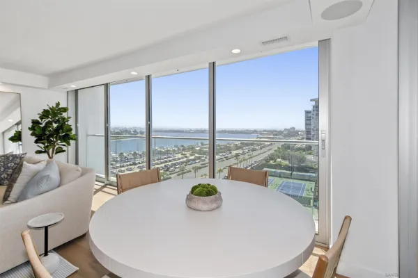 a dining room with furniture and a potted plant