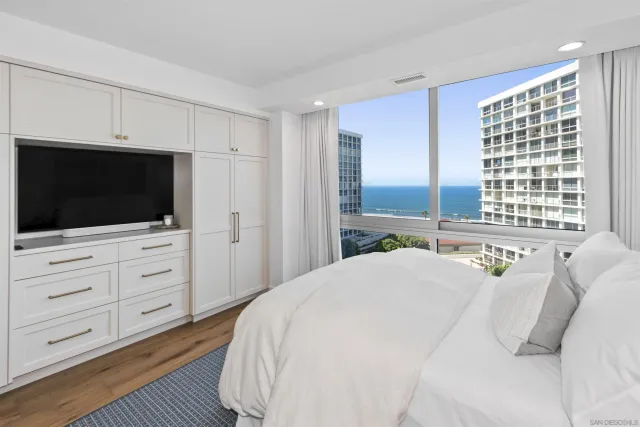 a bedroom with a bed and a flat screen tv