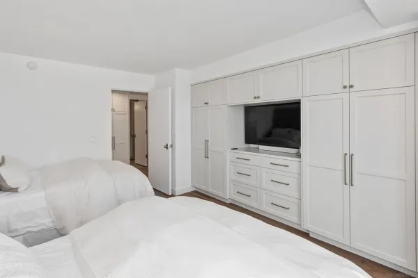 a bedroom with a bed and a flat screen tv
