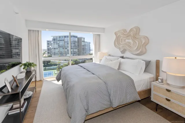 a bedroom with a bed and a large window