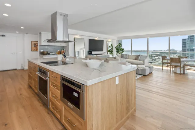 a kitchen with a stove and a wooden floor