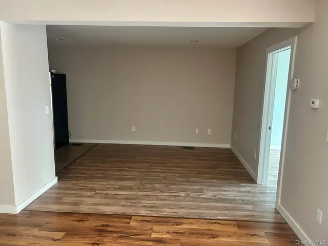 a view of a room with wooden floor