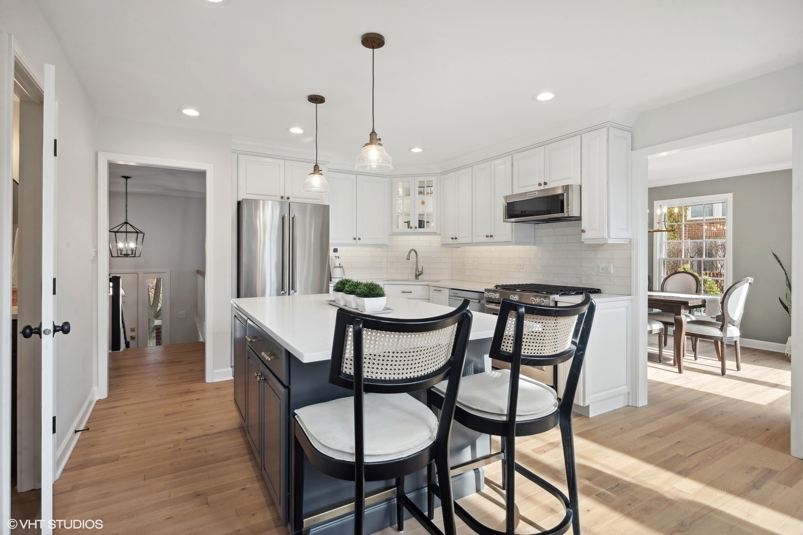 853 Seminary Circle Glen Ellyn, IL 60137 - Photo 6 of 26 a kitchen with stainless steel appliances kitchen island granite countertop a dining table chairs and refrigerator