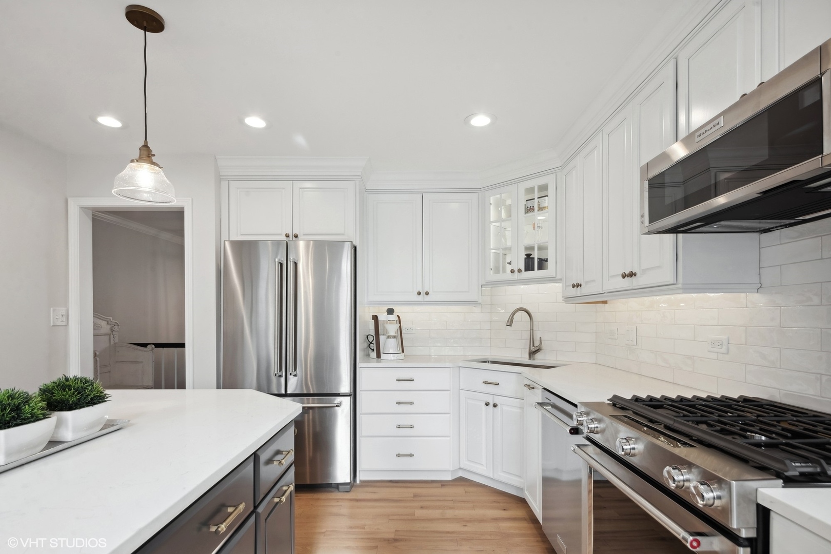 853 Seminary Circle Glen Ellyn, IL 60137 - Photo 8 of 26 a kitchen with white cabinets and stainless steel appliances
