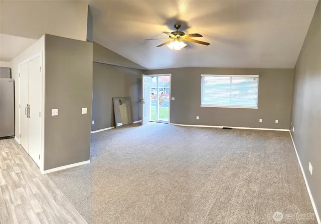 an empty room with closet and chandelier fan