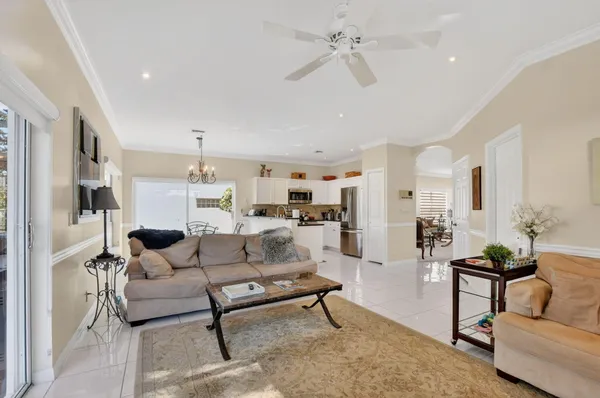 a living room with furniture and a view of kitchen