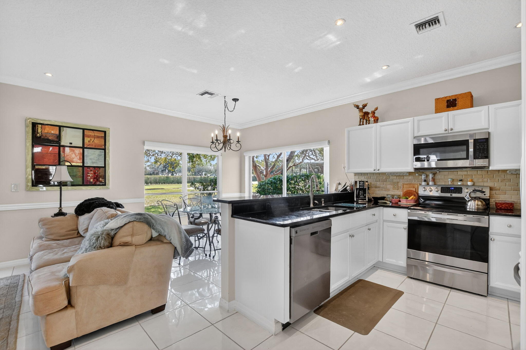 7323 Panache Way Boca Raton, FL 33433 - Photo 16 of 46 a kitchen with stainless steel appliances granite countertop a sink and a stove