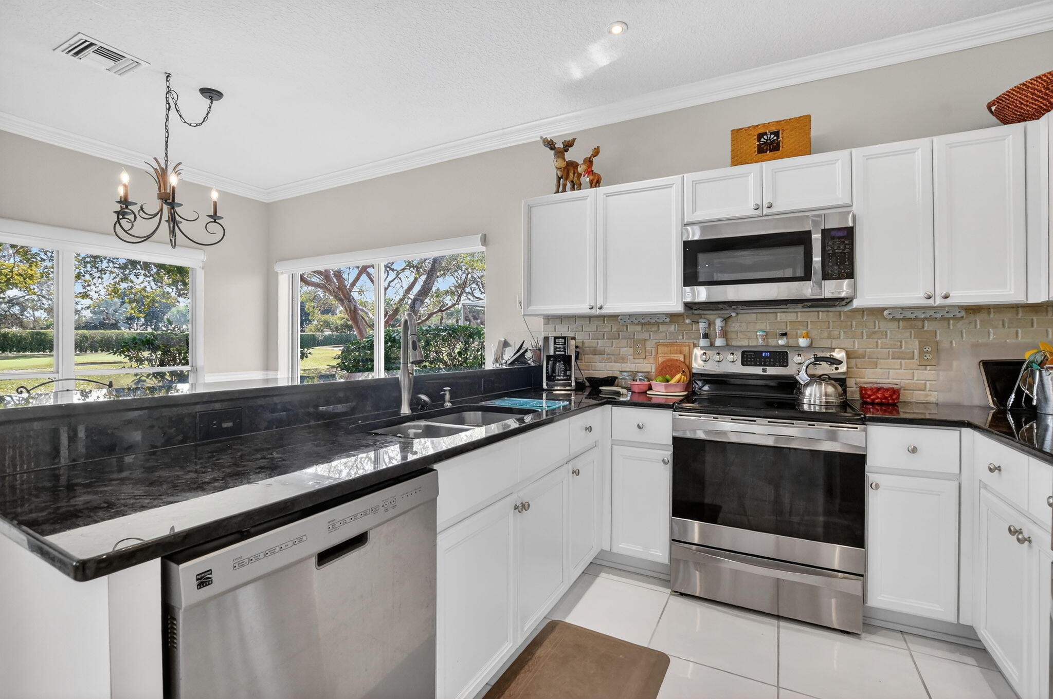 7323 Panache Way Boca Raton, FL 33433 - Photo 18 of 46 a kitchen with granite countertop a sink a stove and cabinets