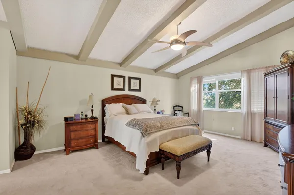 a bed room with a bed and a chair