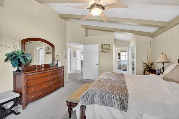 a bed room with a bed and a potted plant