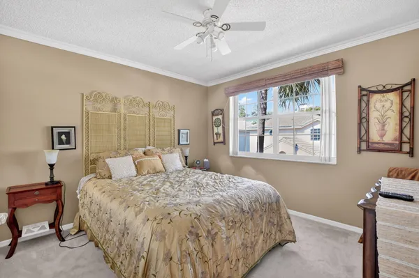 a bed sitting in a bedroom next to a window