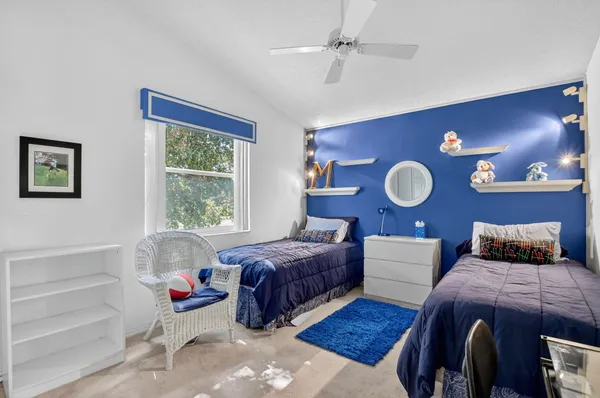 a bedroom with bed and wooden floor